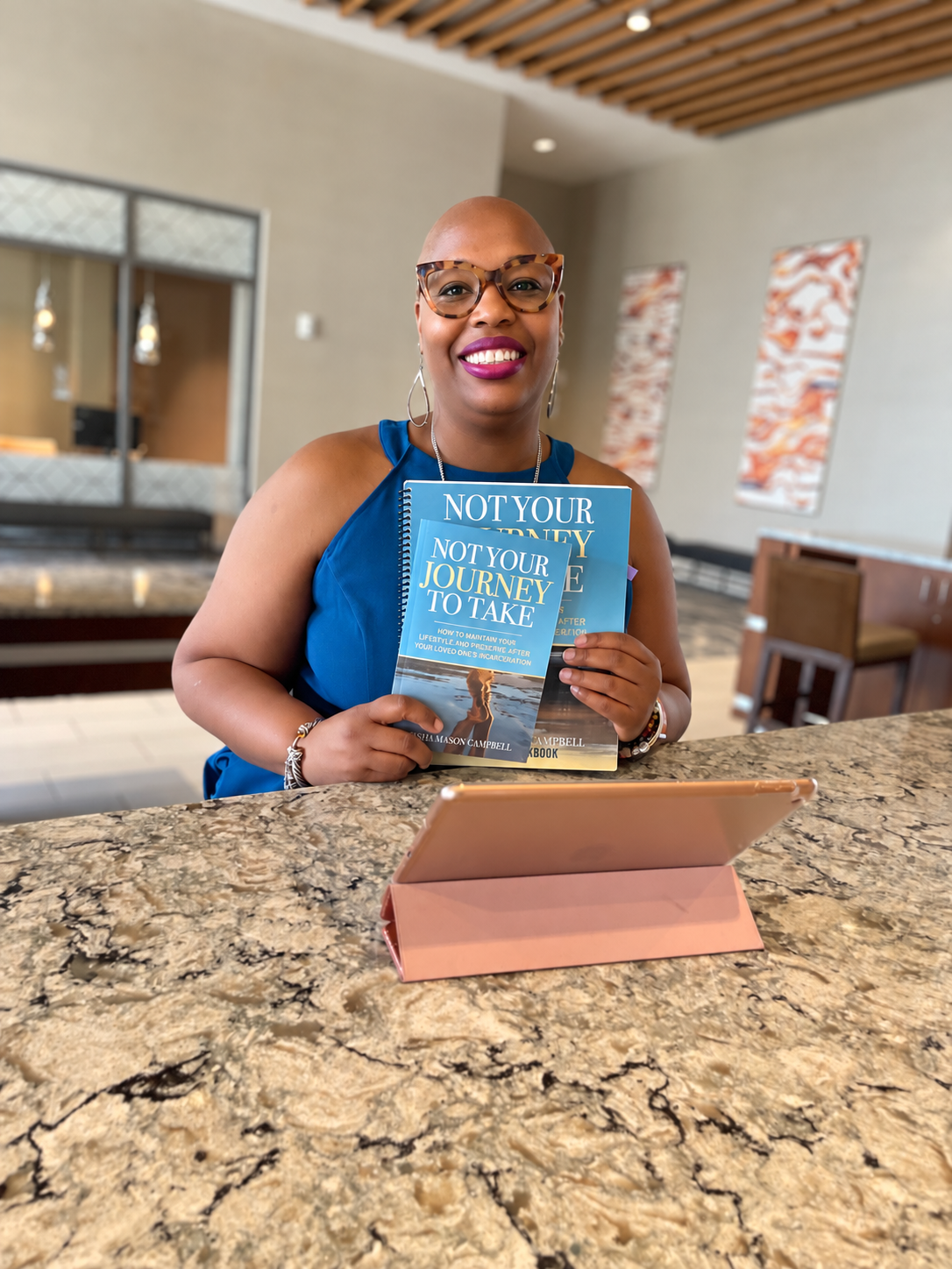 Kesha Mason Campbell holding the Not Your Journey To Take book